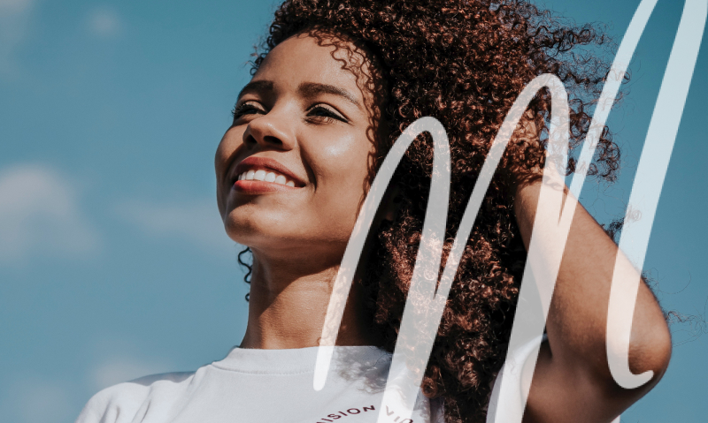woman smiling and playing with her hair